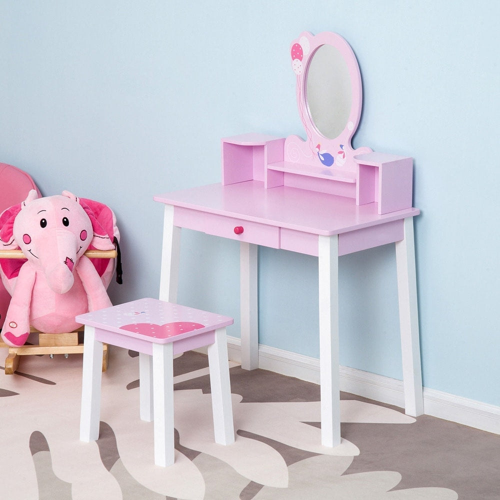 The dressing table set placed in a child's bedroom next to a pink elephant toy