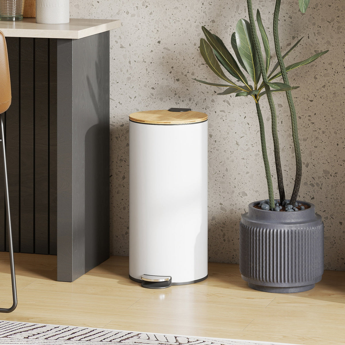 The white pedal bin with a natural wood lid is placed next to a kitchen counter