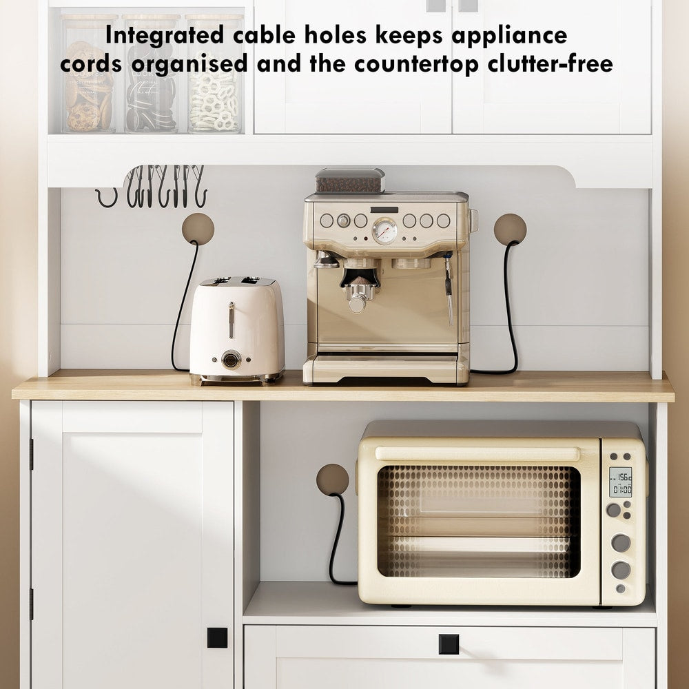 The kitchen cabinet has integrated cable holes to keep cords tidy