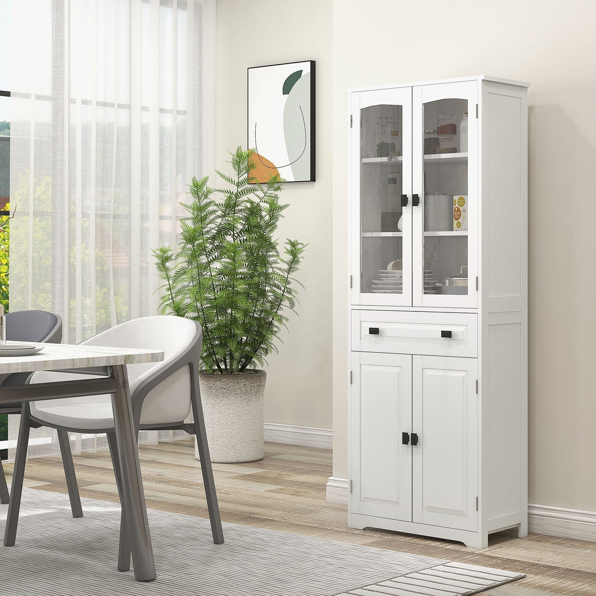 The white kitchen furniture cabinet shown in a dining room setting with a table and plant