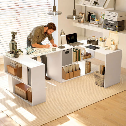The office desk in a large room with a man working at the workspace