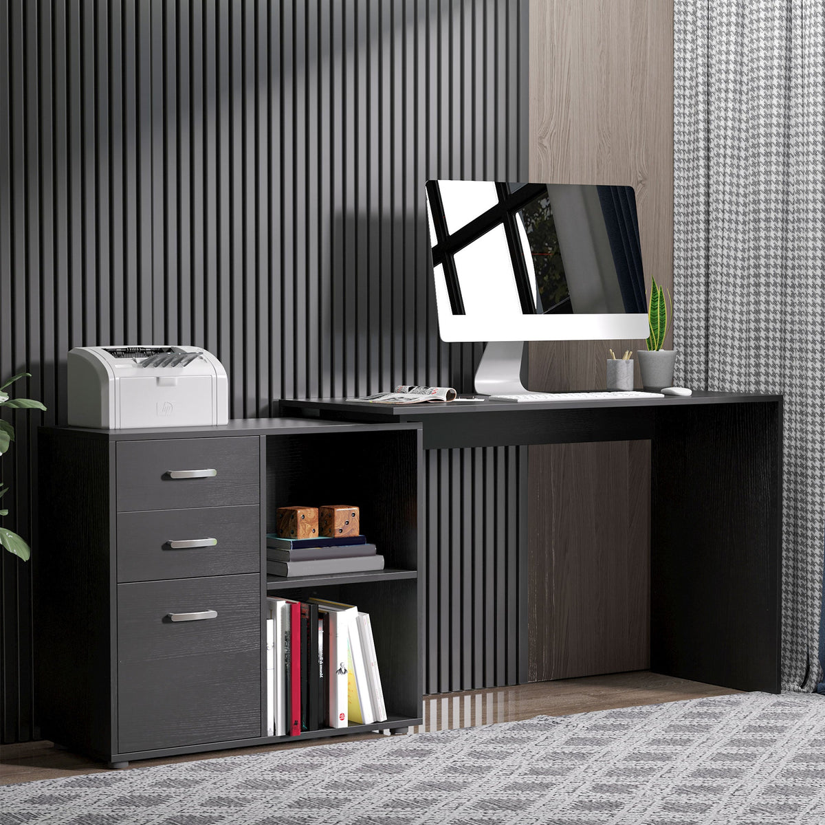 The black L shaped computer desk set up in a home office with a computer and printer