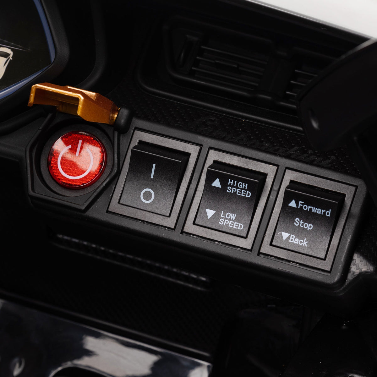 The dashboard of the ride-on car showing the power button and speed control switches