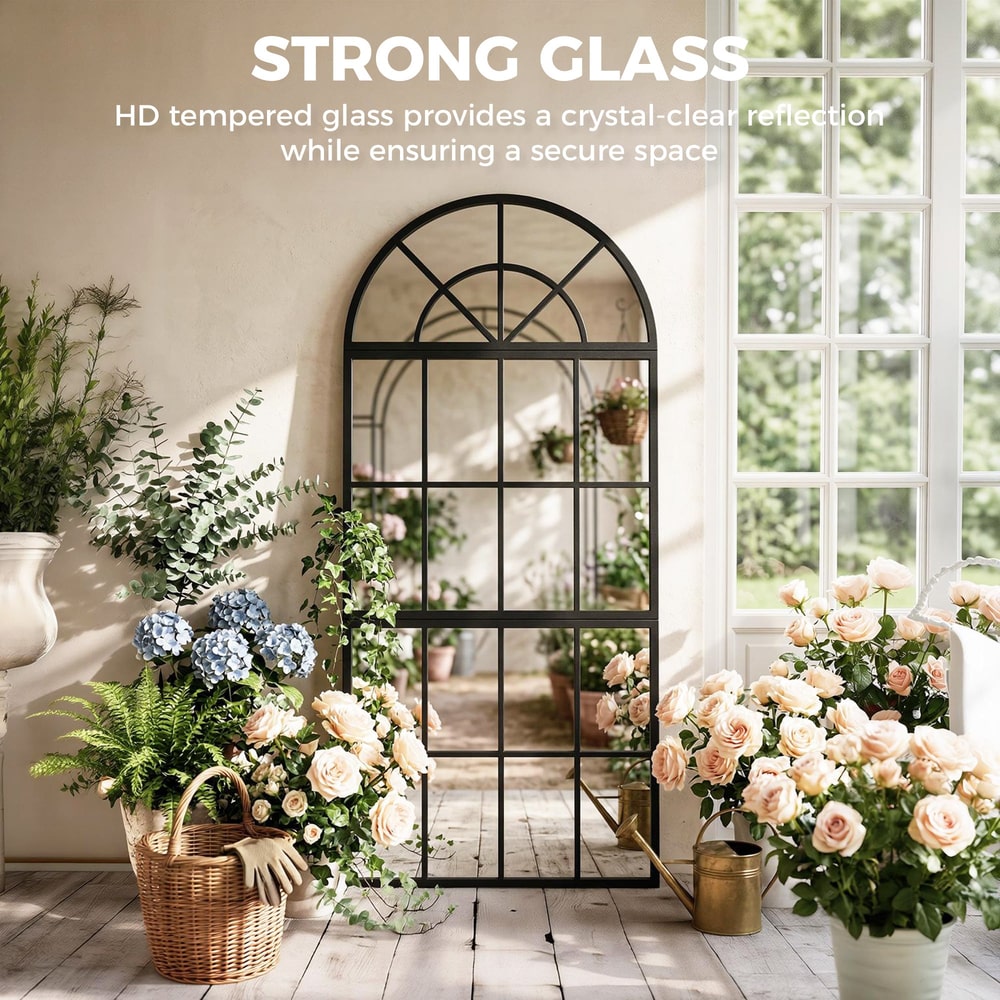 The large arched wall mirror with metal grid reflecting a garden scene, made with strong glass