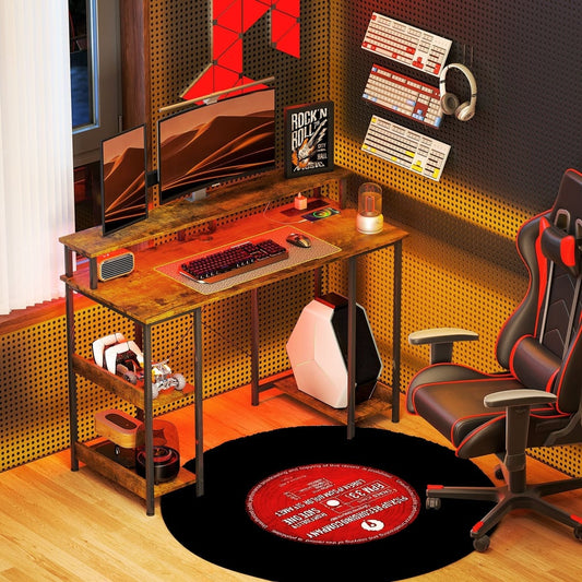 The computer desk set up in a room with a computer, gaming chair and accessories