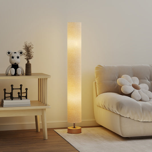 The standing lamp in a living room next to a sofa and a side table