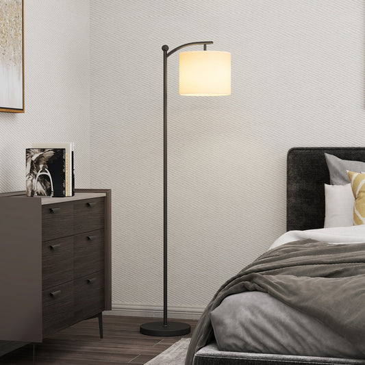 The black floor lamp with remote control is lit up in a modern bedroom setting next to a bed
