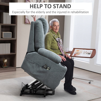 Elderly woman sitting in a grey fabric lift and recline armchair, demonstrating its ease of use