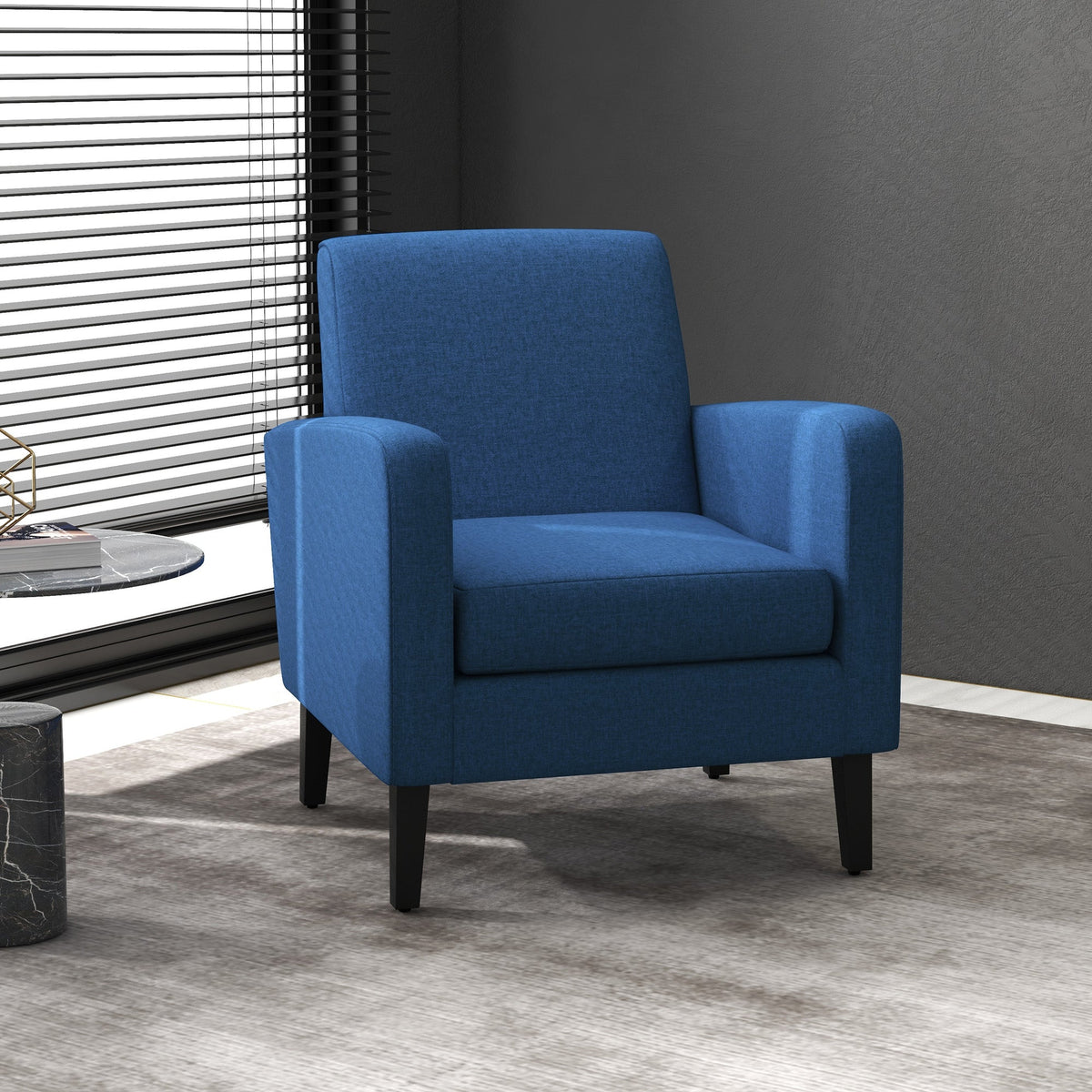 Blue linen-look armchair in a modern living room setting next to a window