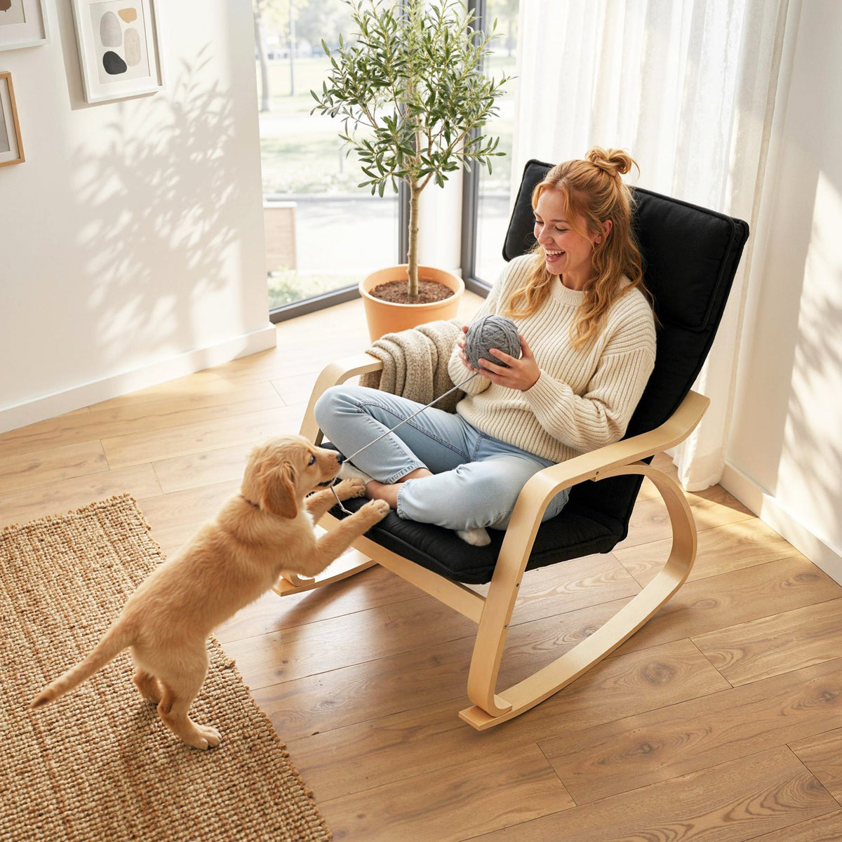 A woman playing with a puppy while sitting in the rocking chair