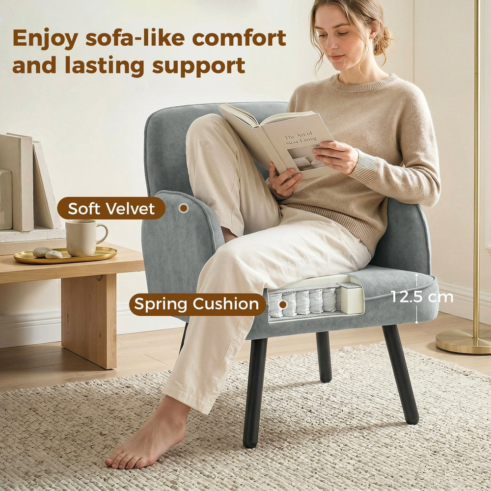Close up of the grey velvet armchair showing soft velvet and spring cushion construction