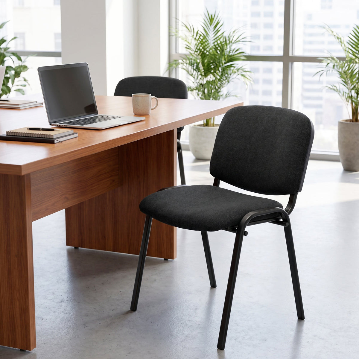The office chair positioned at a desk in a bright room with large windows
