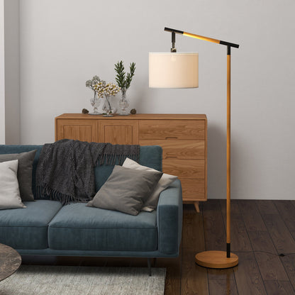The floor lamp in a living room next to a blue sofa and wooden cabinet