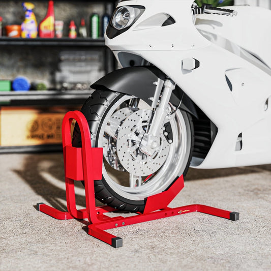 Red metal motorcycle wheel chock holding a white motorbike front tyre