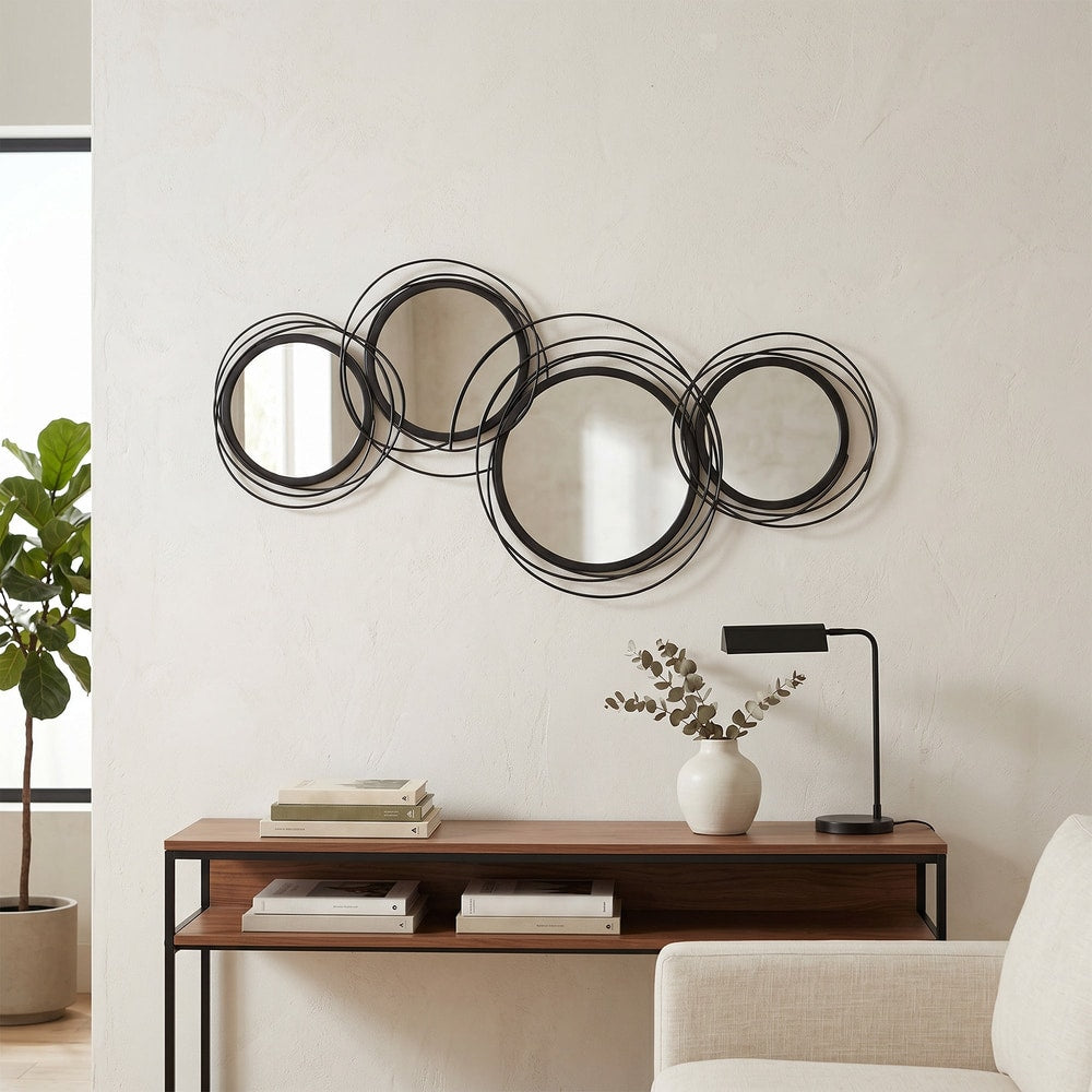 modern decorative mirror decor above a console table with books and a lamp