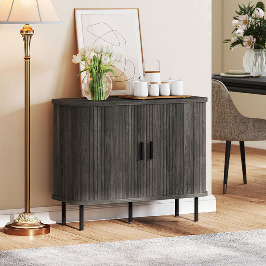 Grey storage cabinet in a dining room next to a table and lamp