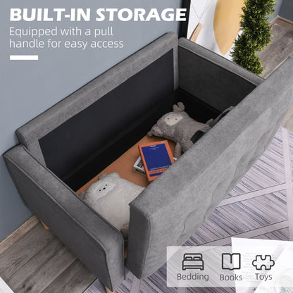 The grey two seater sofa with its storage compartment open, showing space for bedding and books