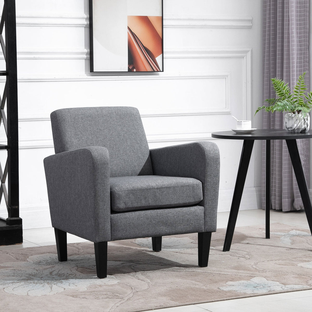 The occasional chair placed in a living room next to a small round side table