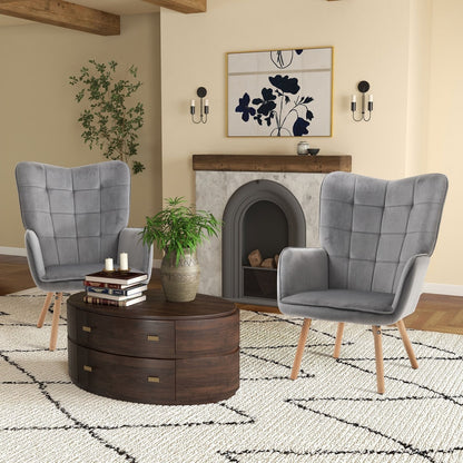 Two grey velvet-touch armchairs with tufted backs and wooden legs in a living room setting