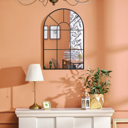 A close-up of the arched wall mirror reflecting a room interior