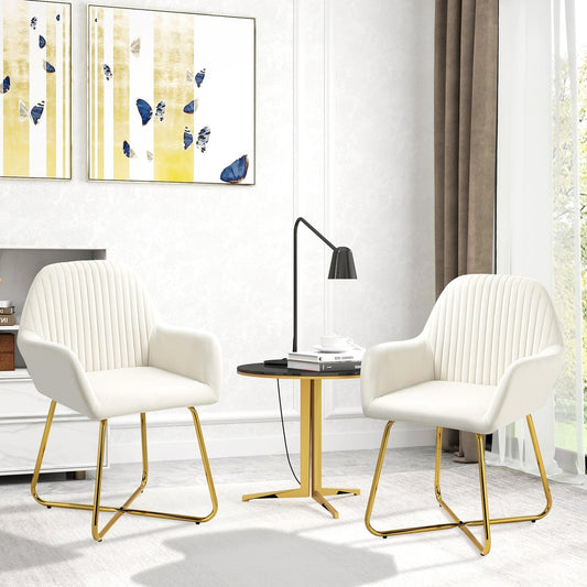 Two cream white upholstered accent chairs with gold metal bases in a living room setting