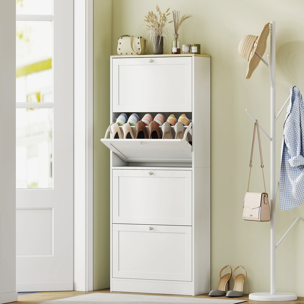 White shoe storage cabinet with four drawers, shown in a hallway with shoes inside