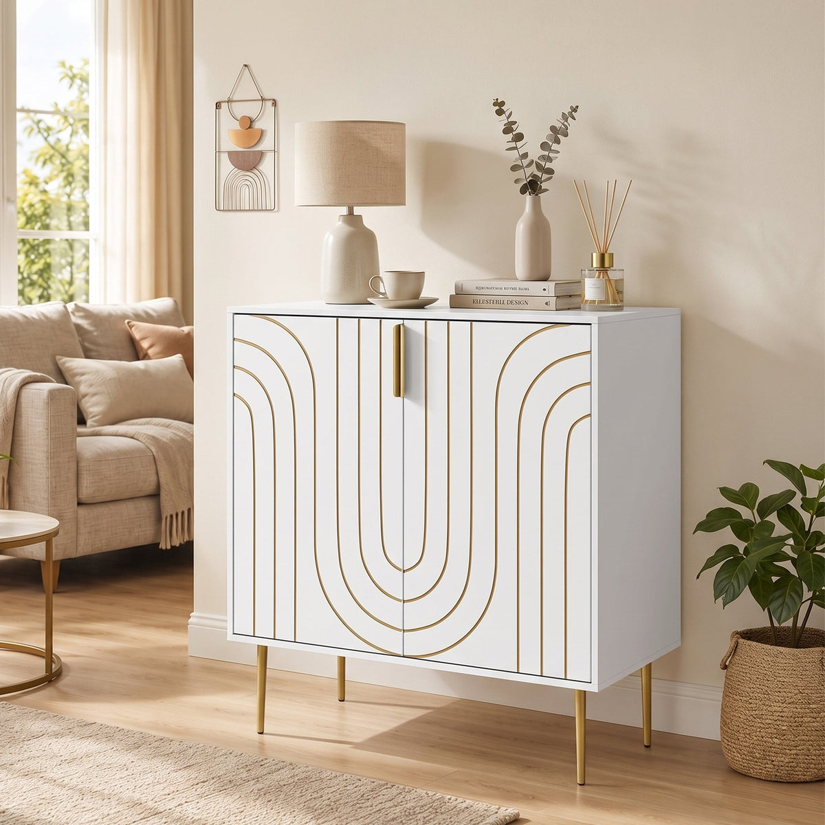 This white storage cabinet with gold curved line details is shown in a living room setting next to a sofa