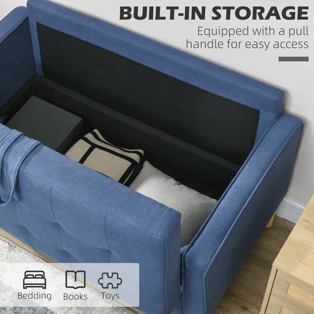 The blue sofa has its storage compartment open, revealing space for bedding and books