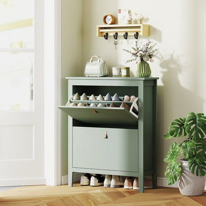 Green shoe storage cabinet with its top drawer open, showing shoes inside, in a hallway setting
