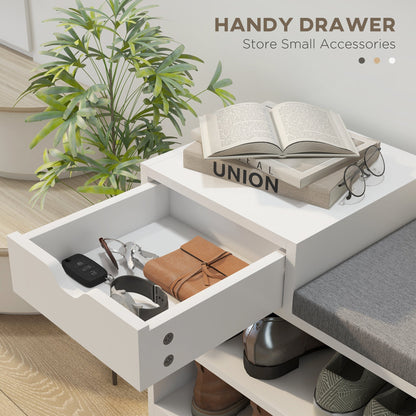 Close-up of the open drawer in the white shoe storage bench, containing keys and a wallet