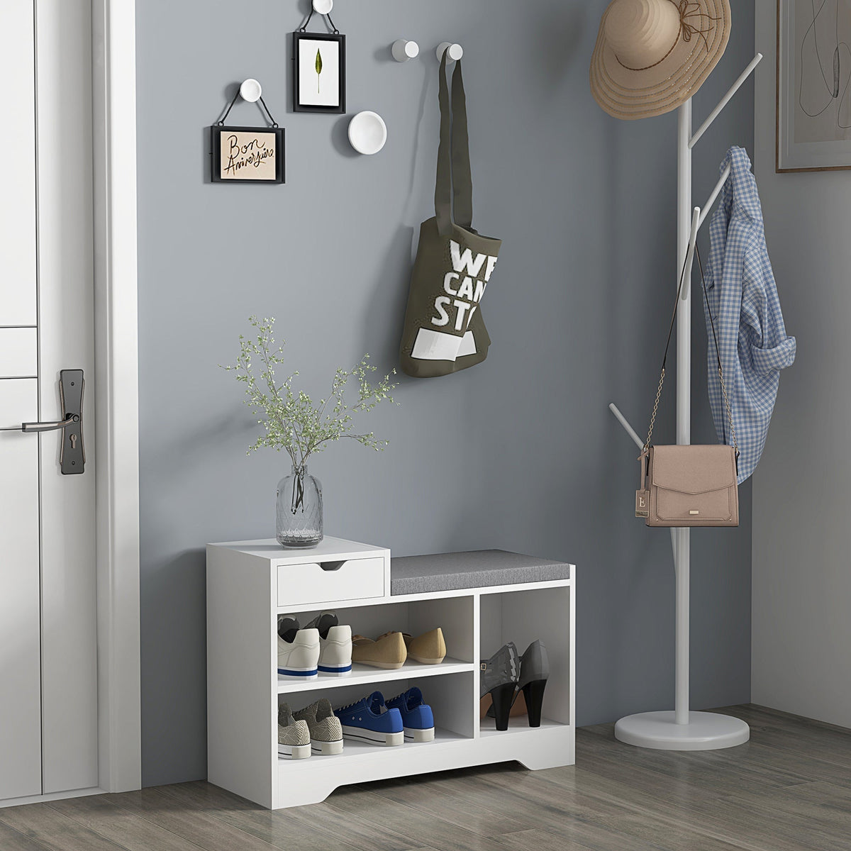White shoe storage bench with a grey cushion in a hallway, holding shoes and accessories