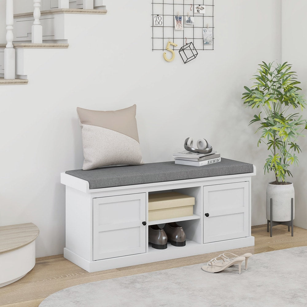 The shoe storage bench with a cushion top is placed in a hallway with shoes inside