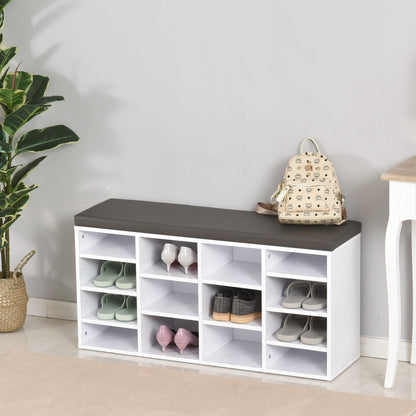 The white shoe storage bench with a dark cushion top is filled with various shoes and a backpack on top