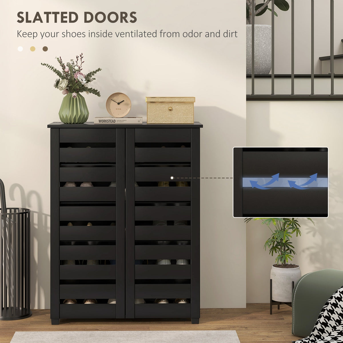 Close up of the slatted doors of the black shoe storage cabinet with ventilation arrows