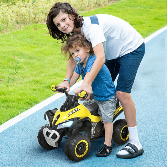Two children enjoying a ride on the yellow foot to floor slider outdoors