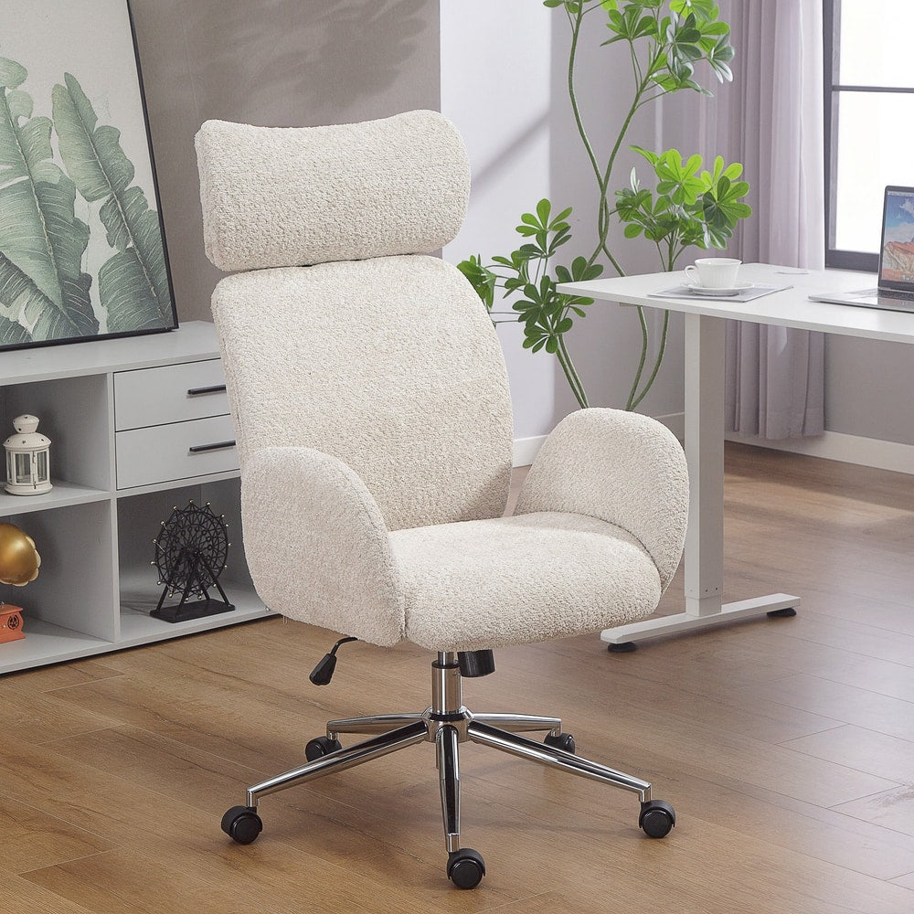 Pale grey boucle fabric office chair with adjustable headrest in a home office setting