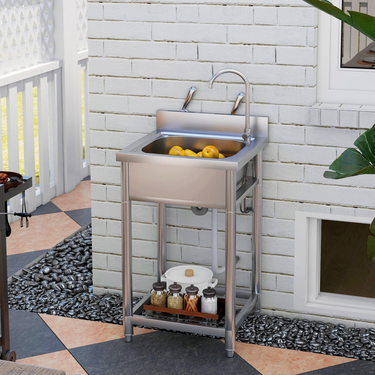 The outdoor utility sink is shown in use next to a barbecue on a patio