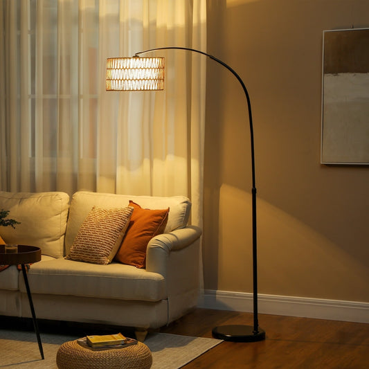 The arc standing lamp is placed next to a sofa in a living room, providing ambient light