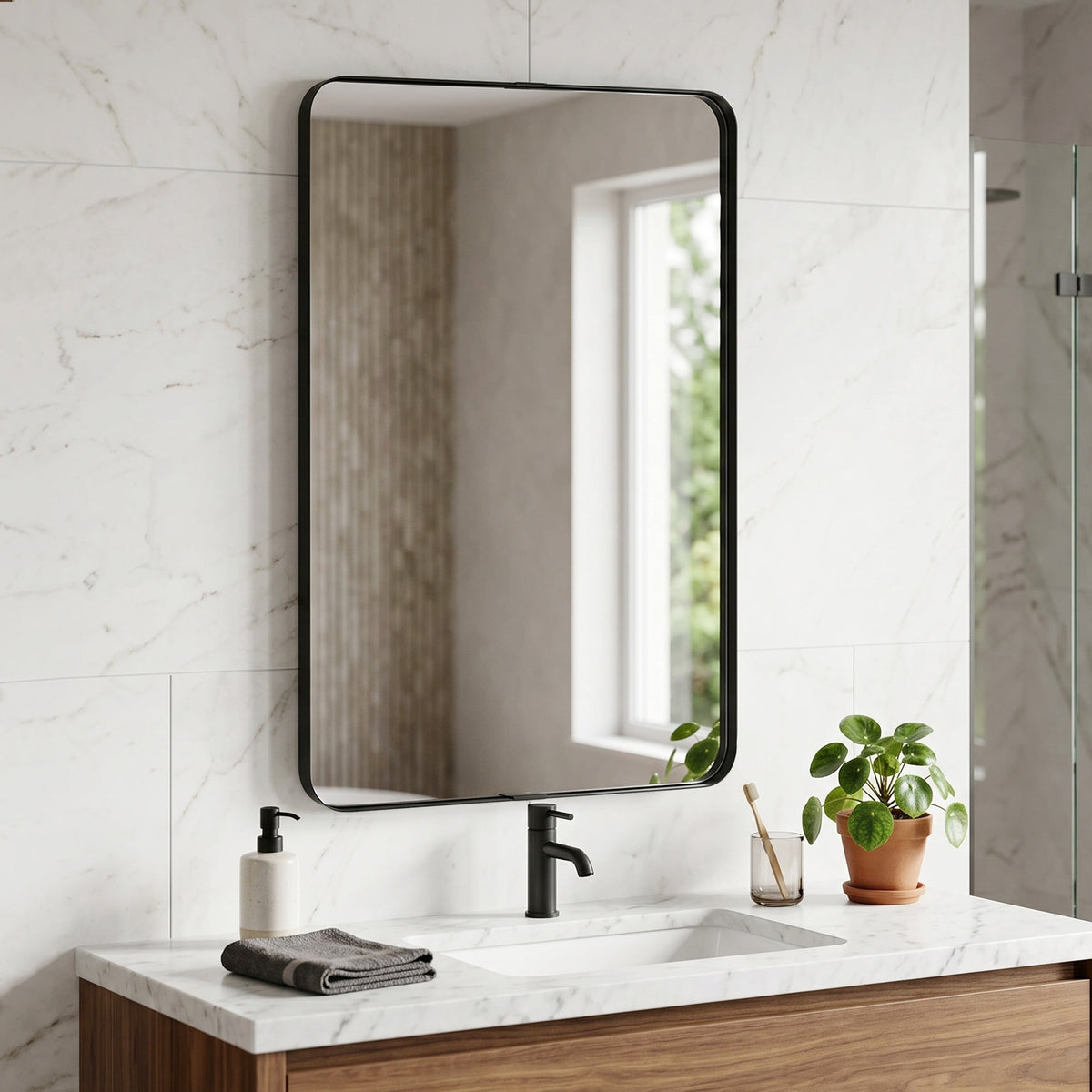 The rectangular wall mirror is mounted above a bathroom sink with a tap and soap dispenser