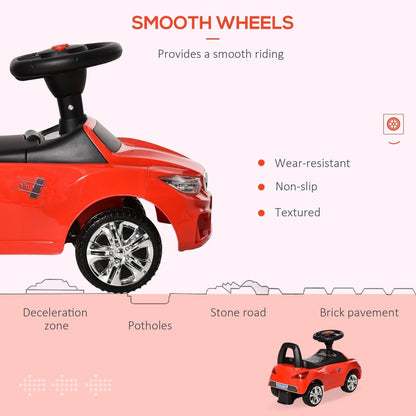 Close up of the red ride-on car showing smooth wheels and different road surfaces