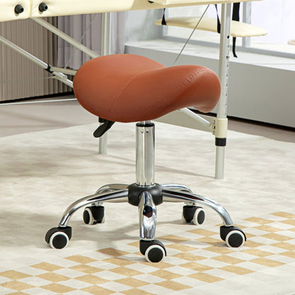 The salon chair positioned on a patterned rug in front of a massage table in a bright room