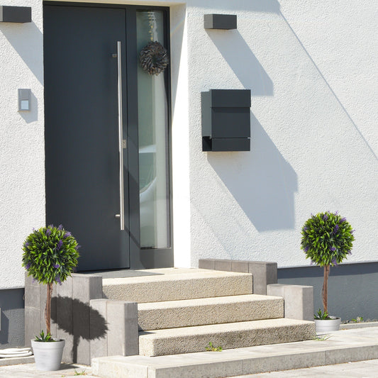 Two artificial ball trees with lavender flowers in pots placed on outdoor steps