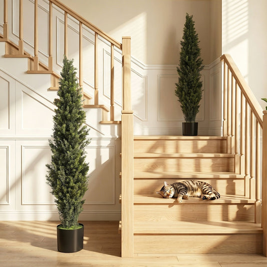 The artificial cypress trees are placed on a staircase landing and a step