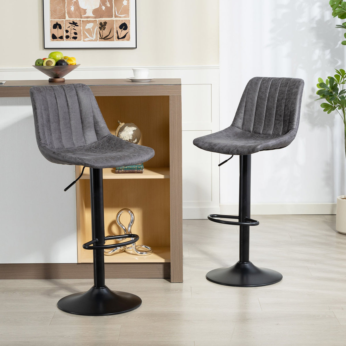 Two charcoal grey tub bar stools in a modern kitchen setting