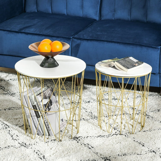 Two round nesting side tables with white marble effect tops and gold wire bases, one holding books and fruit in a living room