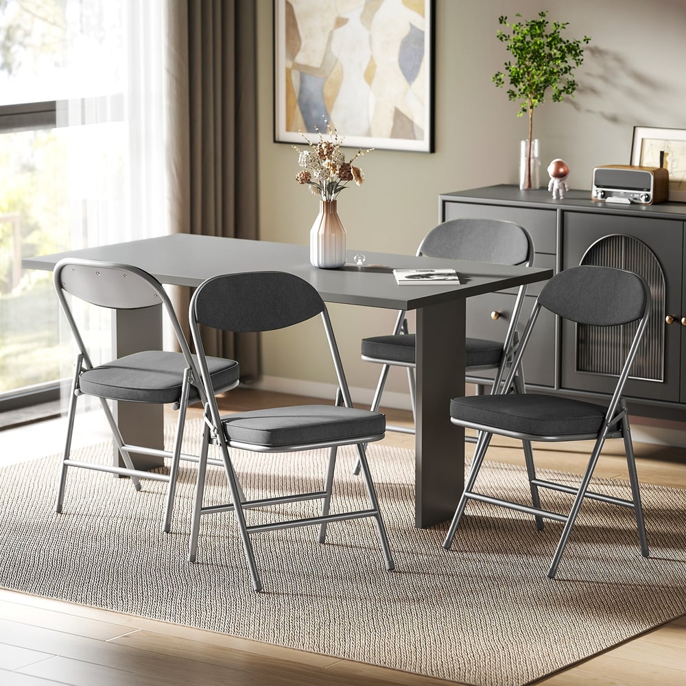 The dining chairs placed around a dark grey table in a modern living room setting