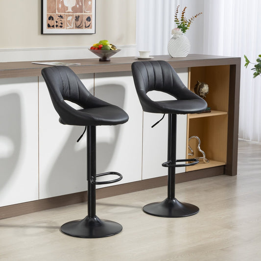 Two black faux leather bar stools placed at a kitchen counter