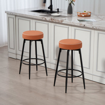 Two brown faux leather bar stools with black metal legs in a modern kitchen setting