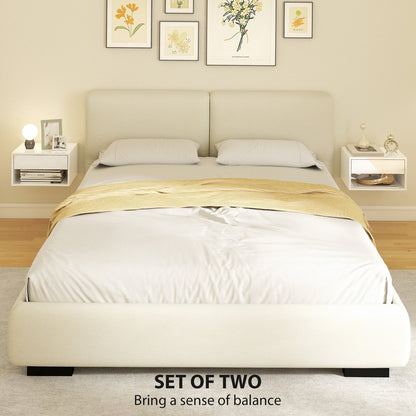 Two white floating bedside tables either side of a bed