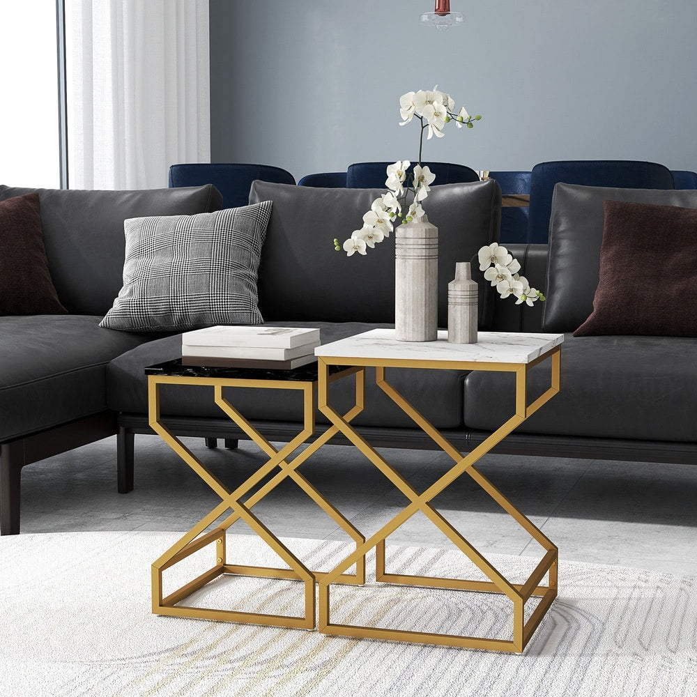 Two marble-effect nesting side tables with gold frames placed next to a sofa